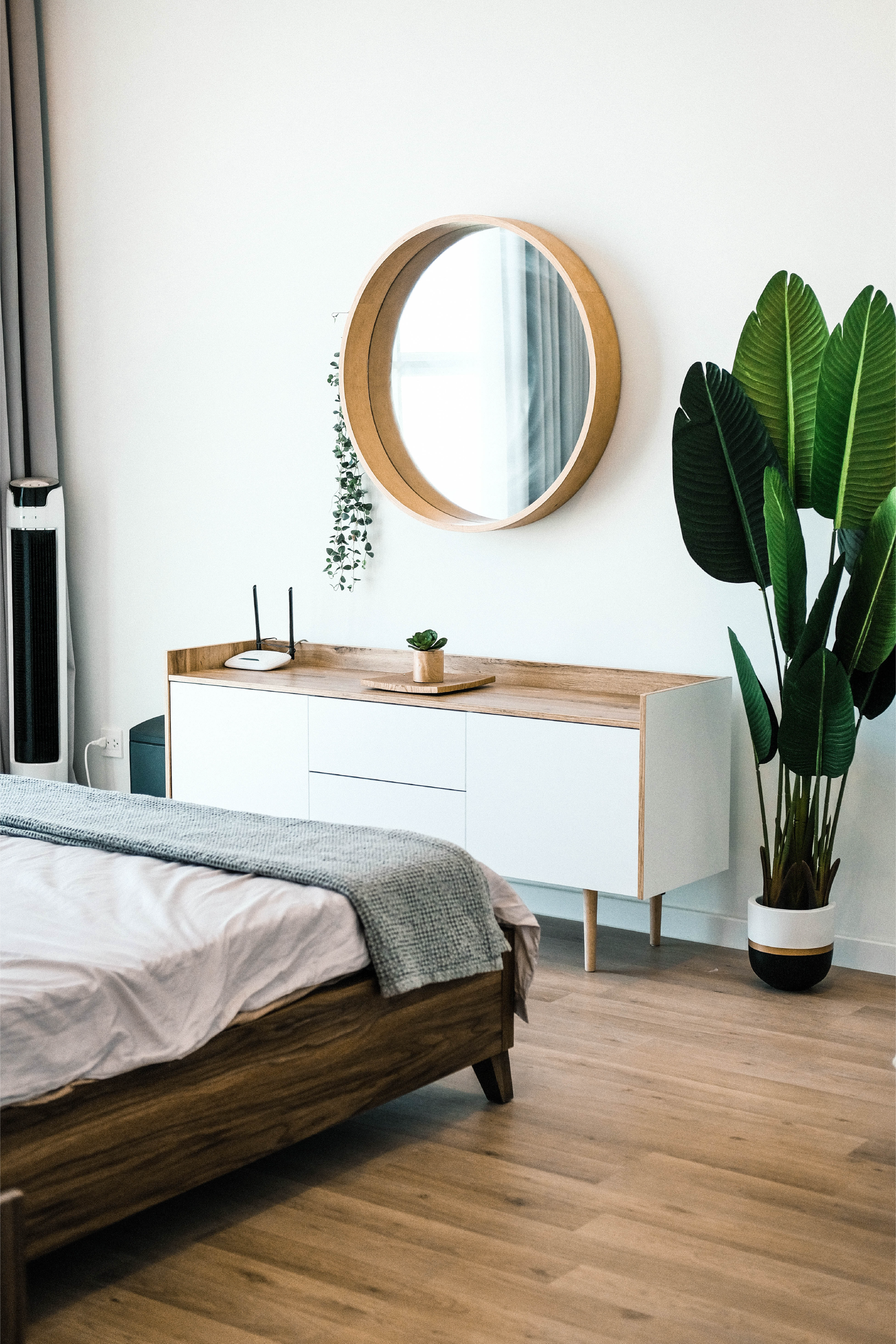 Image of bedreoom with mirror, chest of drawers, and bed