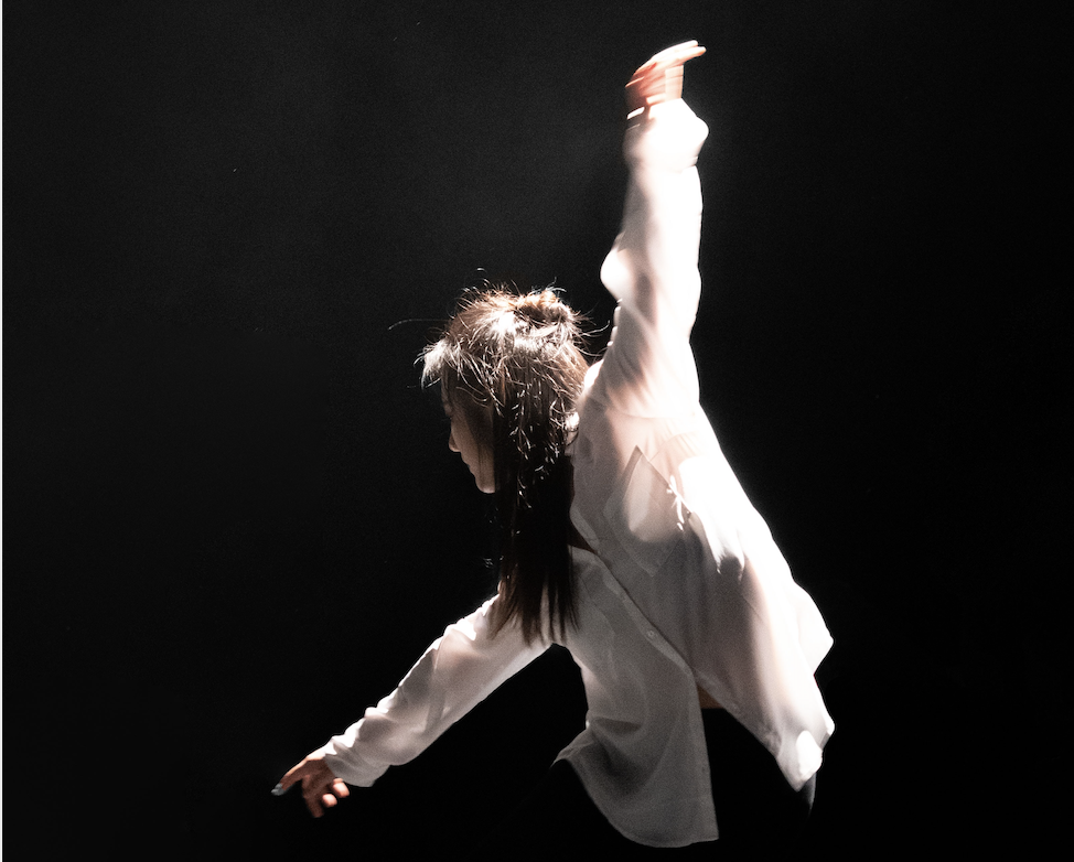 SDF dancer on stage in white shirt